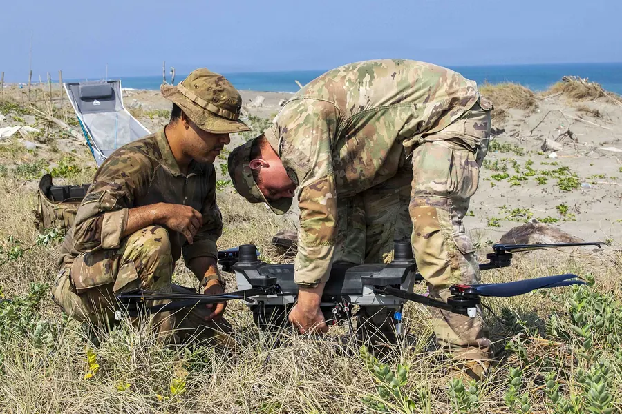 Two soldiers assembling a drone in the field