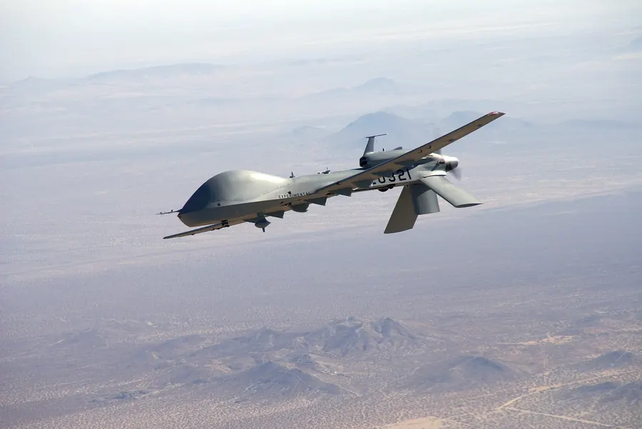 A medium-altitude long-endurance drone in flight over desert